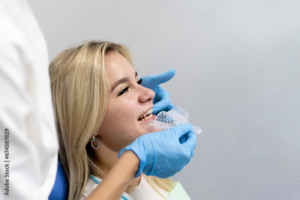 otrhodontist making teeth impression mold in a plastic tray, orthodontic treatment concept otrhodontist making teeth impression mold in a plastic tray, orthodontic treatment concept