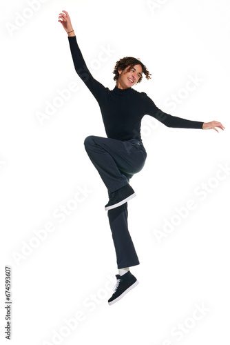 Full length portrait of attractive curly man jumping of joy, happiness isolated white studio background. Concept of beauty, youth, sales, emotions, fashion, style, modelling. Copy space for ad, text.