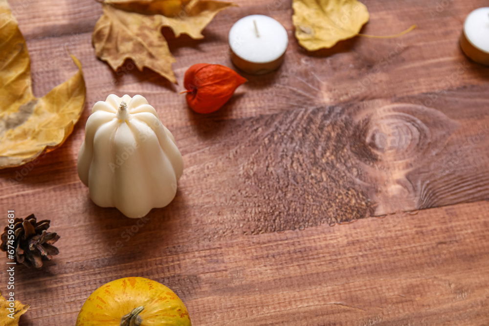 Composition with candles and autumn decor on wooden background Composition with candles and autumn decor on wooden background