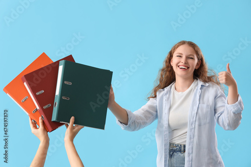 Young woman showing thumb-u...
