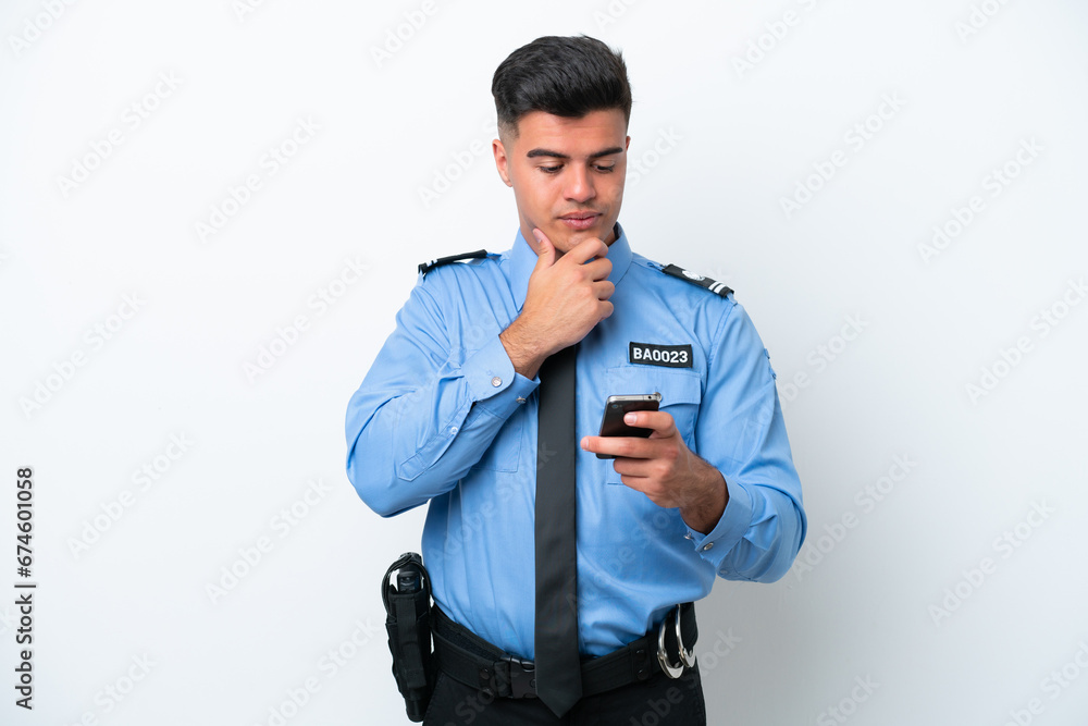 Young police caucasian man isolated on white background thinking and sending a message Young police caucasian man isolated on white background thinking and sending a message