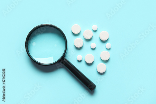 Magnifier with pills on blu...
