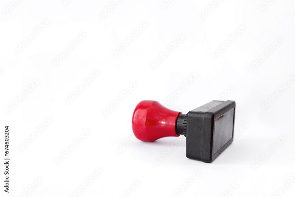 Close up photo of red and black plastic stamp isolated on white background. Close up photo of red and black plastic stamp isolated on white background.