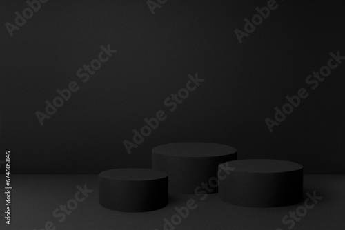Abstract black scene with three cylinder podiums template for presentation cosmetic products, goods, advertising, design, poster, text, card. Black stage template in rich contemporary minimal style.