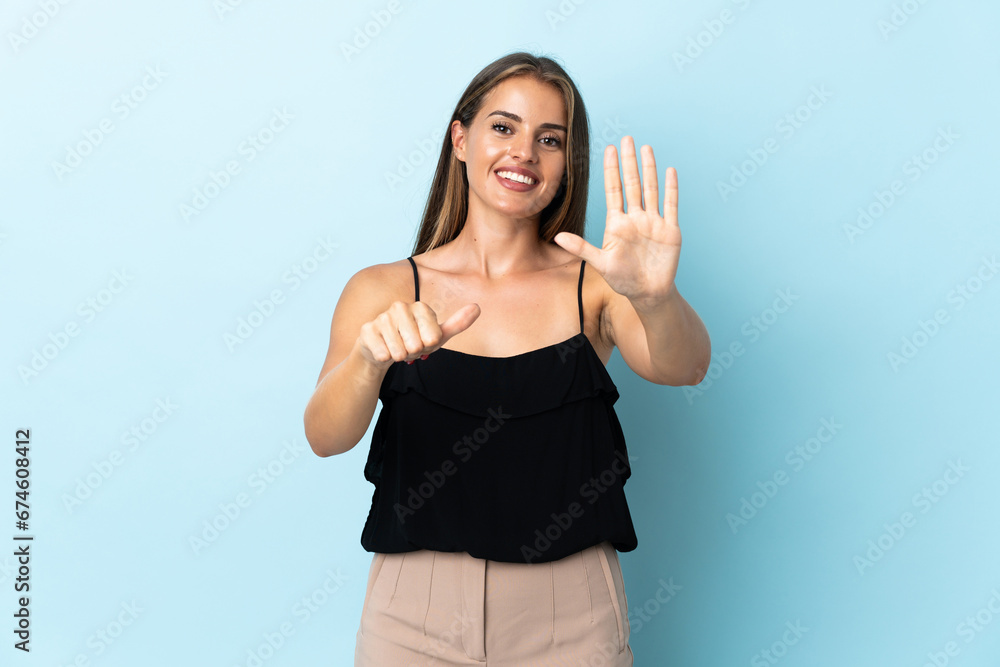 Young Uruguayan woman isolated on blue background counting six with fingers Young Uruguayan woman isolated on blue background counting six with fingers