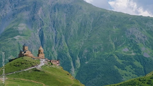 Historical Gergeti Trinity Church on Caucasus Mountains background photo