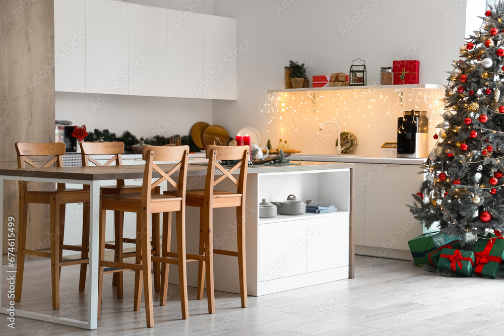 Interior of kitchen with counters and Christmas tree