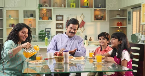 Happy Family Eating Breakfast At table
