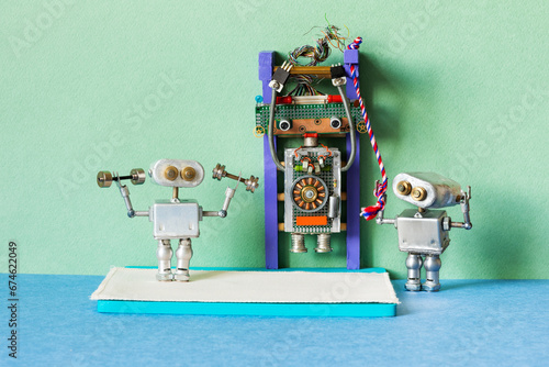 A toy gym, train weightlifters robots. Robots sportsman do exercises with dumbbells and pull up on the horizontal bar.