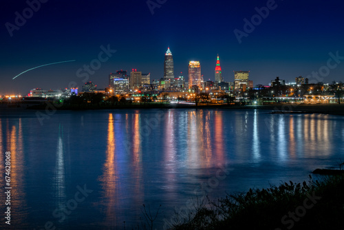 City of Cleveland Lights Reflecting in the Water with Airplane Light Trail