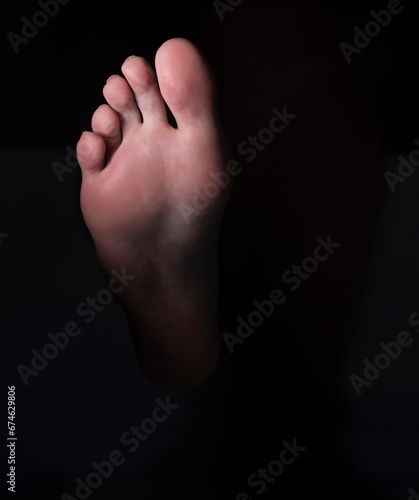 Sole and toes of the female foot on a black background © vladimirfloyd