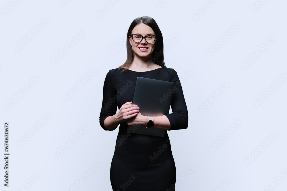 Portrait of young business woman holding laptop, on white background Portrait of young business woman holding laptop, on white background