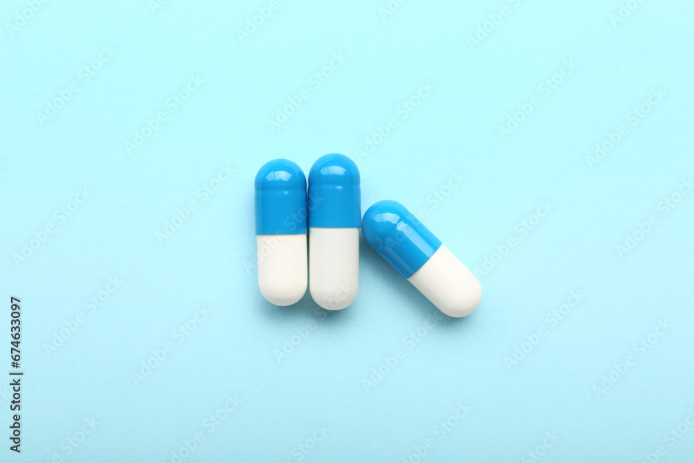 Medical capsules on blue background Medical capsules on blue background