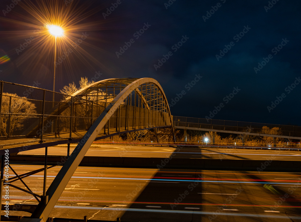 Long Exposure Shot of Highway at Night with Car Light Trails with Bridge