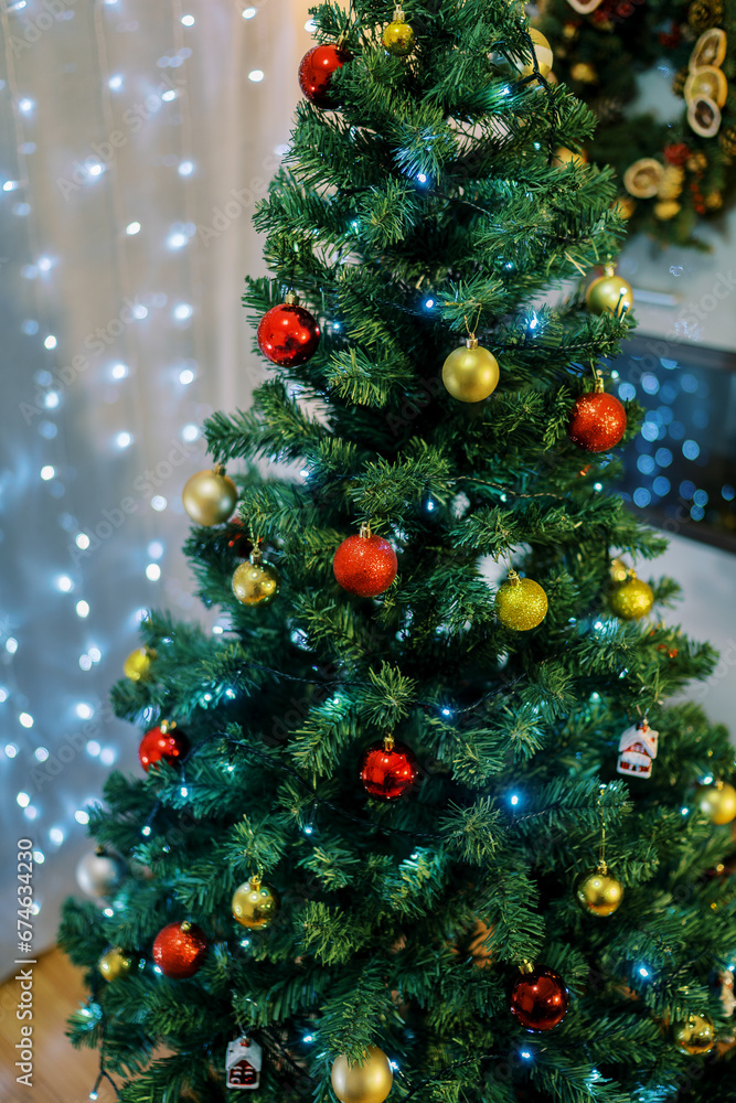 Christmas tree decorated with sparkling garlands and colorful balls