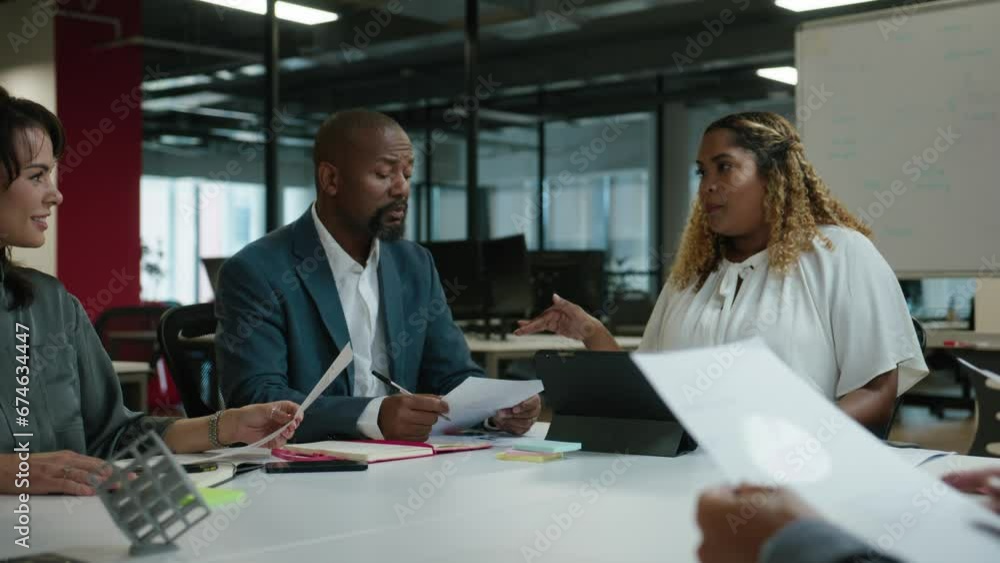 Group of multiracial business people in businesswear with pie chart having discussion during corporate meeting in office Group of multiracial business people in businesswear with pie chart having discussion during corporate meeting in office