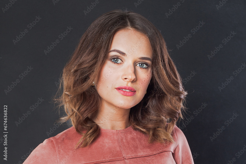 Beautiful female face on black background. Young brunette woman with makeup and natural healthy skin portrait Beautiful female face on black background. Young brunette woman with makeup and natural healthy skin portrait