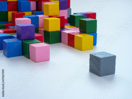 Colored cubes opposite gray. Being different or depression concept.