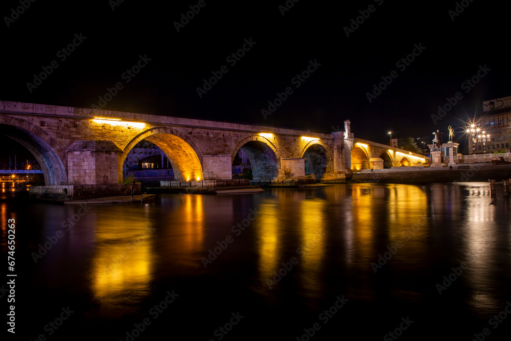 Panoramic night view of a Stone Bridge and river Vardar in Skopje city center