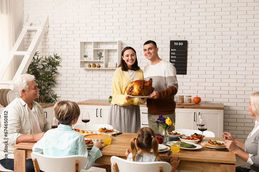 Happy family having dinner at festive table on Thanksgiving Day Happy family having dinner at festive table on Thanksgiving Day