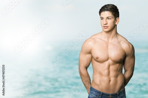 Portrait of handsome young sporty man on the beach