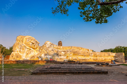 Large white reclining Buddha statue at Wat Lokayasutharam. Ayutthaya Historical Park, Thailand photo