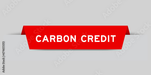 Red color inserted label with word carbon credit on gray background