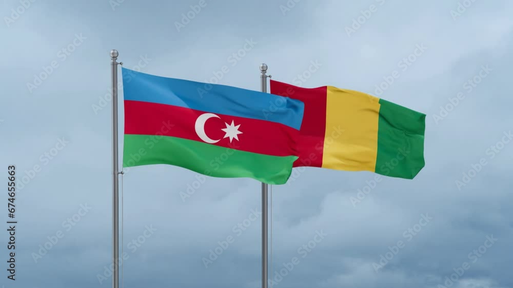 Republic of Guinea flag and Azerbaijan flag waving together on cloudy sky, endless seamless loop, two country relations concept Republic of Guinea flag and Azerbaijan flag waving together on cloudy sky, endless seamless loop, two country relations concept