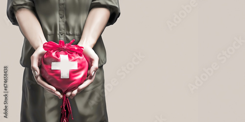 Compassionate person Extends a Helping Hand with Red Aid Bag with White Cross Symbol