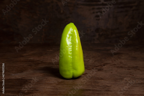 Green bell pepper on wooden background. .