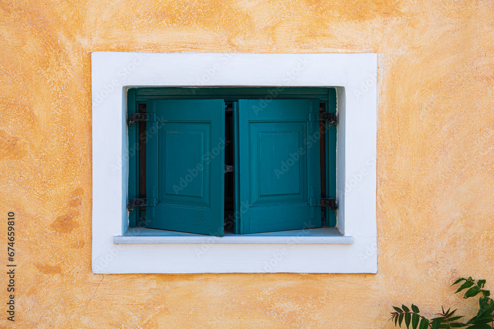 Green window on a Greek traditional house