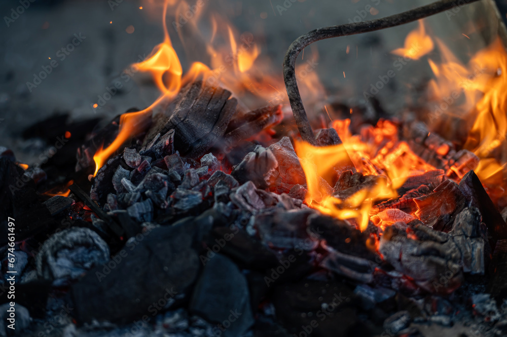 Close up of bonfire with flame and firewood outdoors Close up of bonfire with flame and firewood outdoors