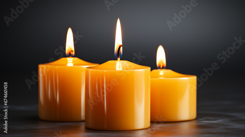  Burning candles. Three yellow candles with dark background with copy space. Conceptual image of prayer, supplication, religious request, eternal flame.