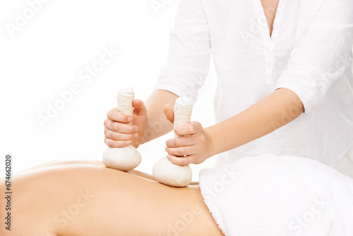 Spa, hot compress and masseuse for massage, treatment and salon care on towel. Skincare, dermatology and therapist with person for relax, calm and wellness for luxury cosmetics on white background
