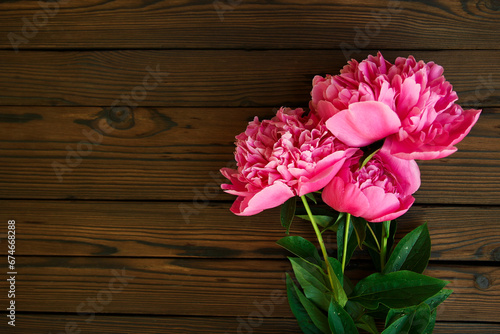 flowers peonies on wooden background holiday