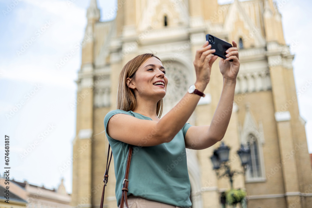 Cropped shot of a young woman taking a selfie while out in the city.