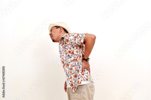 Fotografie Asian man traveler feeling unwell, pain in back spine vertebrae problems