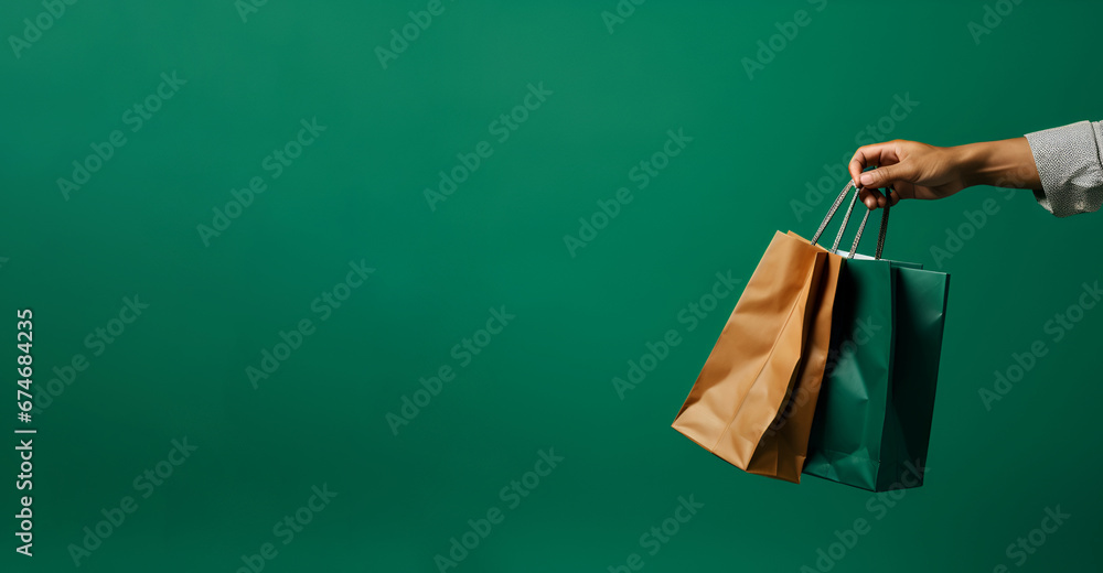 Man holding a shopping bag on a green background