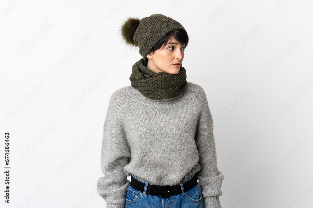 Young girl with winter hat looking to the side Young girl with winter hat looking to the side