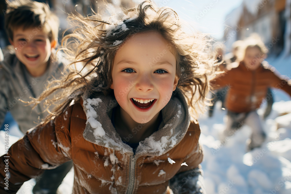 Children play snowballs outside in winter, warm children's comfortable clothes. The concept of a happy childhood. Children play snowballs outside in winter, warm children's comfortable clothes. The concept of a happy childhood.