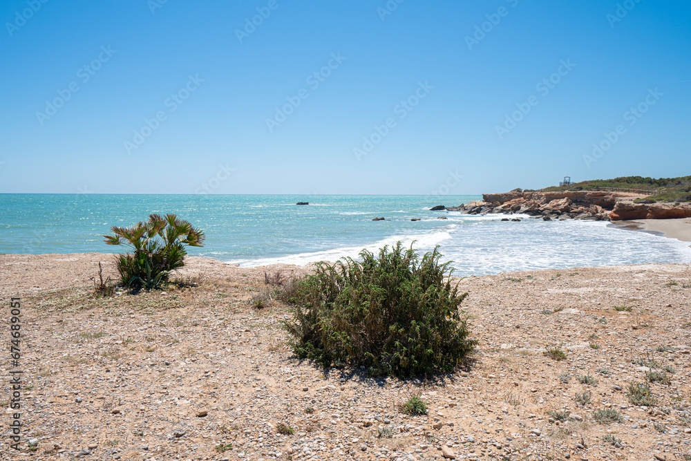 Beach on a sunny day. Mediterranean coast, sea. Alcossebre, Valencia Spain. Beach on a sunny day. Mediterranean coast, sea. Alcossebre, Valencia Spain.