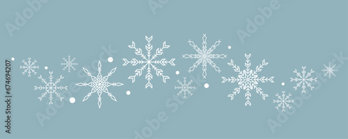 Snowflakes isolated on blue background. Wave of snowflakes.