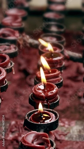Vertical ambient motion of candlelight offerings for the dead, a catholic religious practice during Undas, Kalag kalag or All Souls Day in the Philippines photo