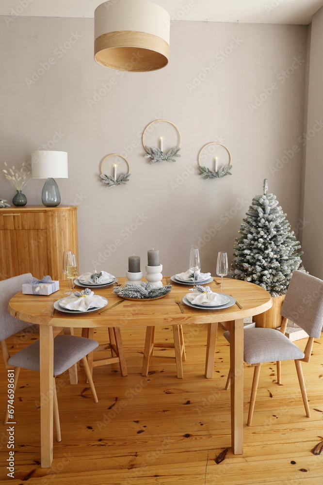 table set for dinner in the apartment decorated for the New Year and Christmas table set for dinner in the apartment decorated for the New Year and Christmas