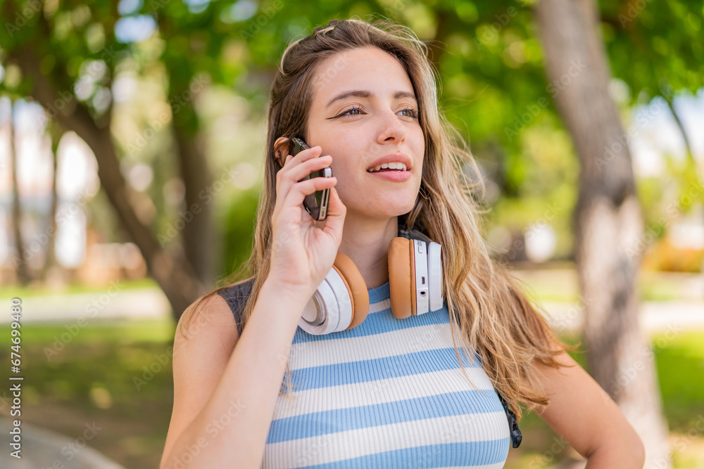 Young pretty woman at outdoors using mobile phone Young pretty woman at outdoors using mobile phone