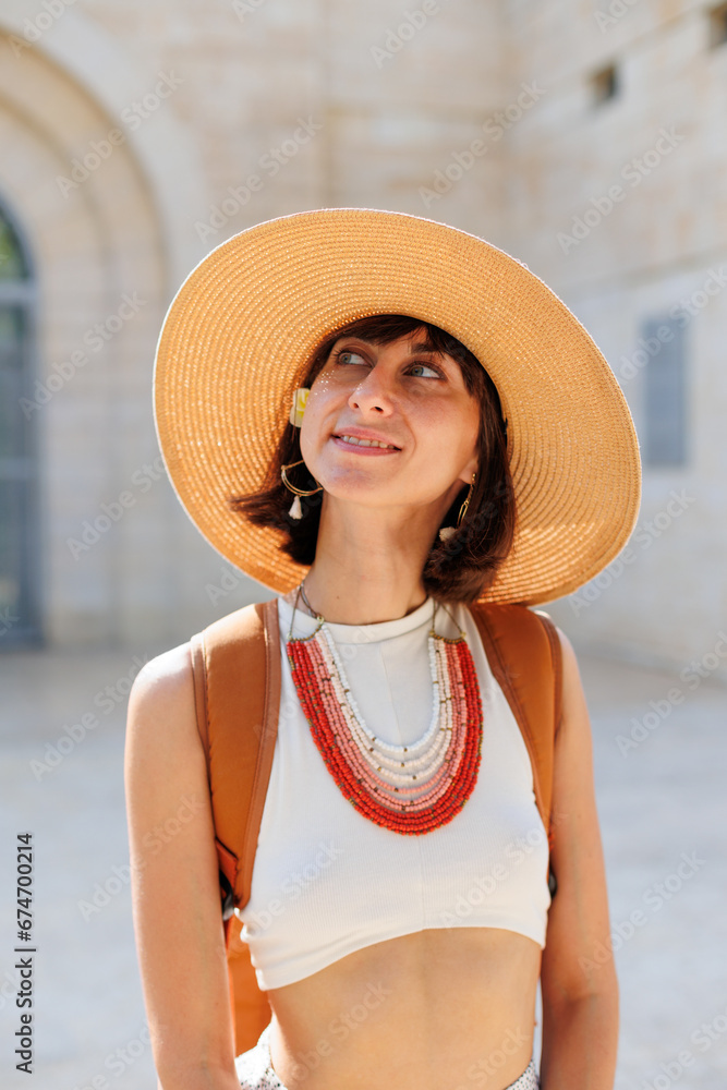 portrait of a young girl in a hat and beads. Fashionable accessories.