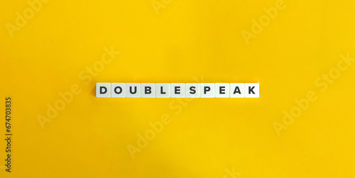 Doublespeak Term on Letter Tiles on Yellow Background. Minimal Aesthetics.