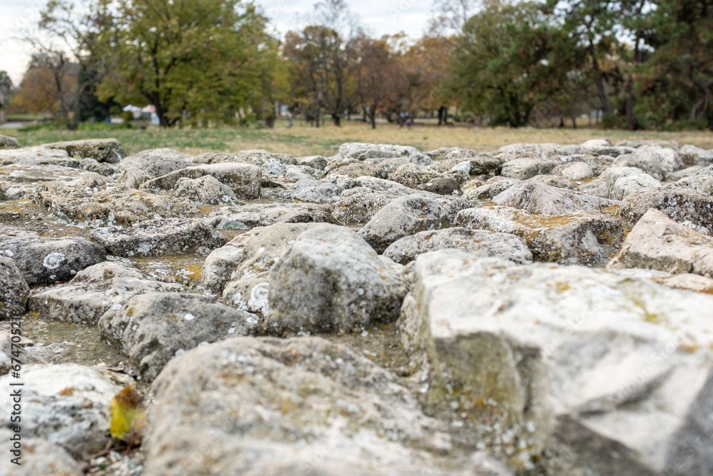 Autumn landscape with large rocks in the foreground and trees in the background for publication, poster, calendar, post, screensaver, wallpaper, postcard, banner, cover, website. High quality photo Autumn landscape with large rocks in the foreground and trees in the background for publication, poster, calendar, post, screensaver, wallpaper, postcard, banner, cover, website. High quality photo