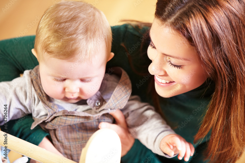Mother, holding and baby with smile for child development with toys for future, growth or milestone in home. Woman, infant or family in living room for bond in relationship with love, care or support Mother, holding and baby with smile for child development with toys for future, growth or milestone in home. Woman, infant or family in living room for bond in relationship with love, care or support