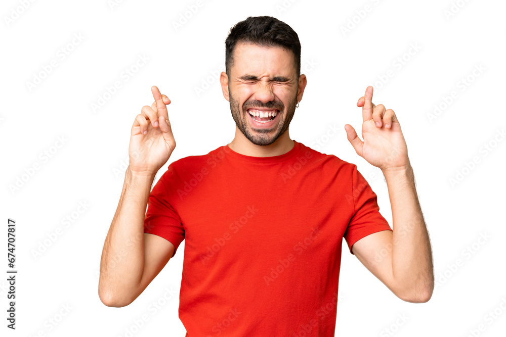 Fototapeta premium Young handsome caucasian man over isolated chroma key background with fingers crossing